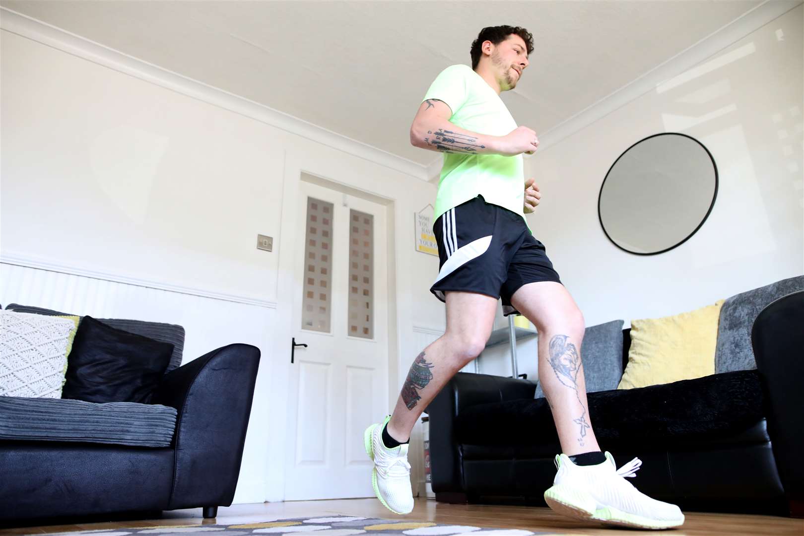 Col Bignell training in his living room (Peter Morrison/PA)