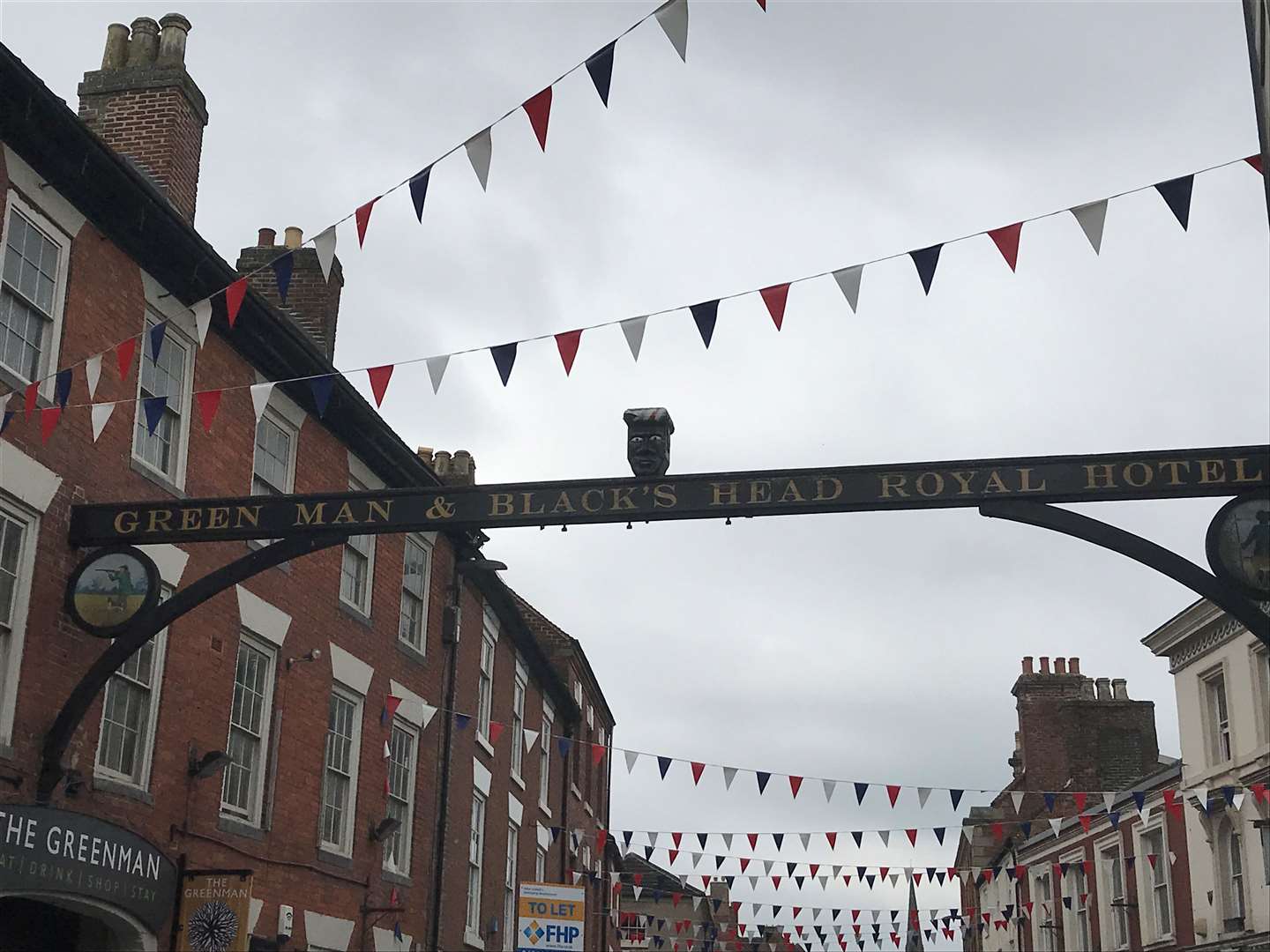 The sign at the Greenman pub in Ashbourne, Derbyshire, before the head was removed (PA)