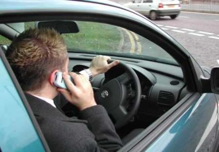 Someone using the phone at the wheel. Picture posed by model.
