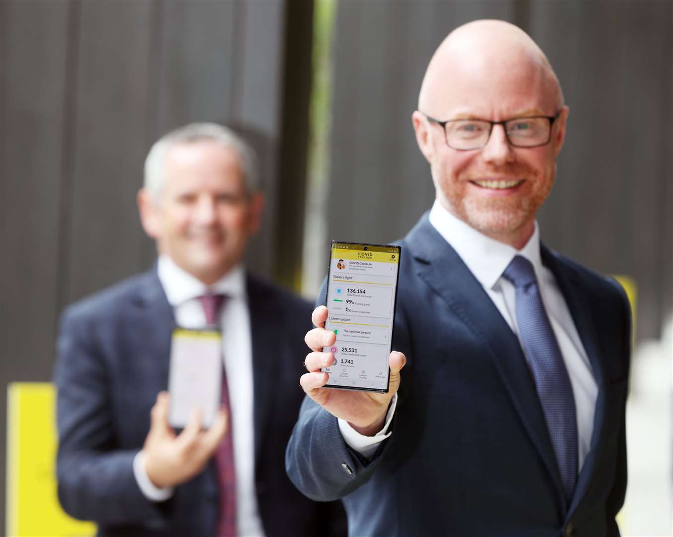 HSE Director General Paul Reid (left) and Health Minister Stephen Donnelly with the official Irish health service executive Covid Tracker contact tracing app (Niall Carson/PA)