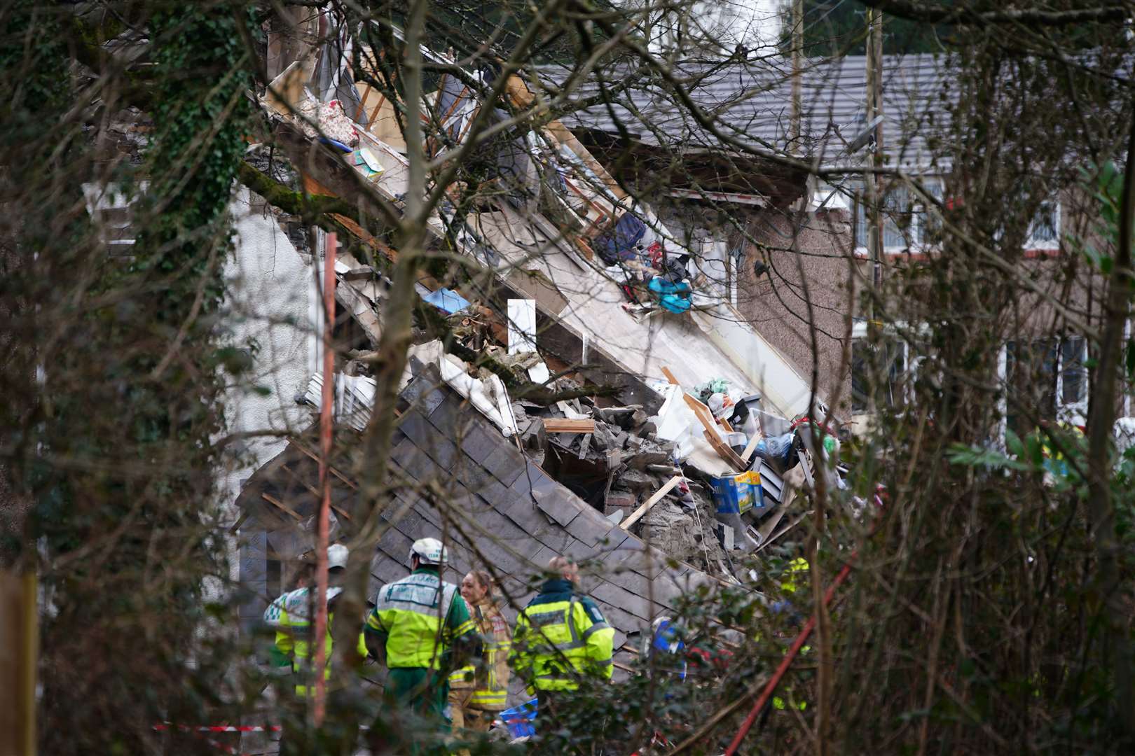 Emergency personnel at the scene after reports of a suspected gas explosion at a property on the junction of Clydach Road and Field Close in Morriston, Swansea (PA)