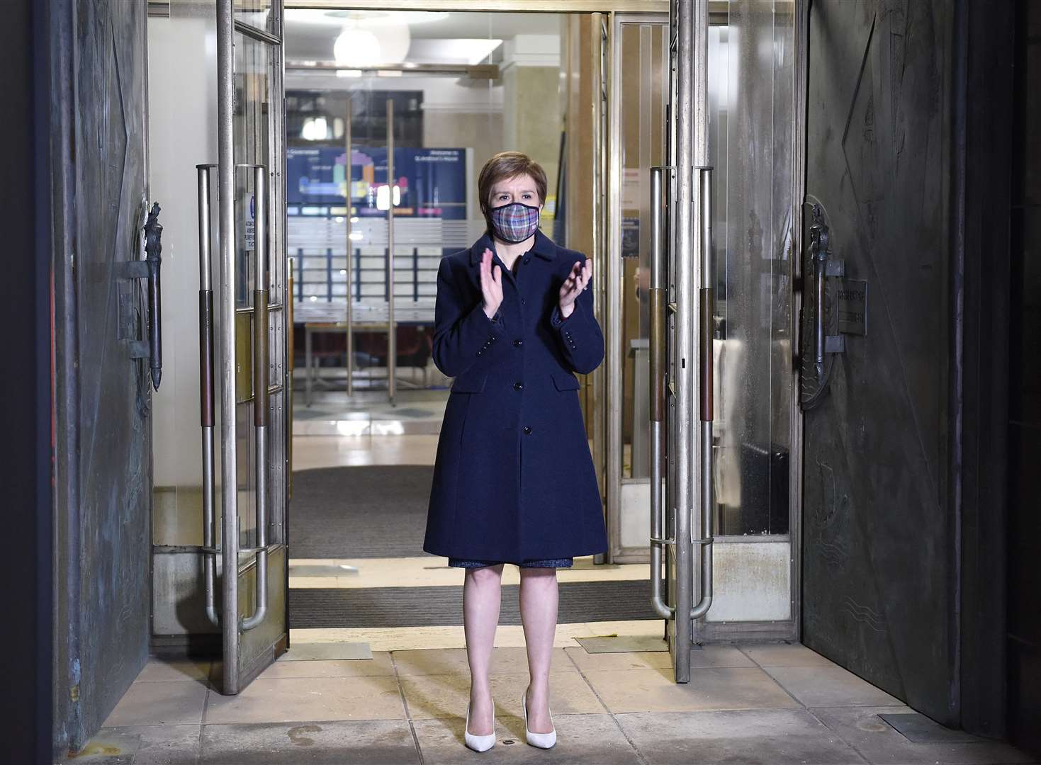 Scotland’s First Minister Nicola Sturgeon takes part in a doorstep clap in memory of Captain Sir Tom Moore at St Andrew’s House, Edinburgh (Callum Moffat/Daily Record/PA)