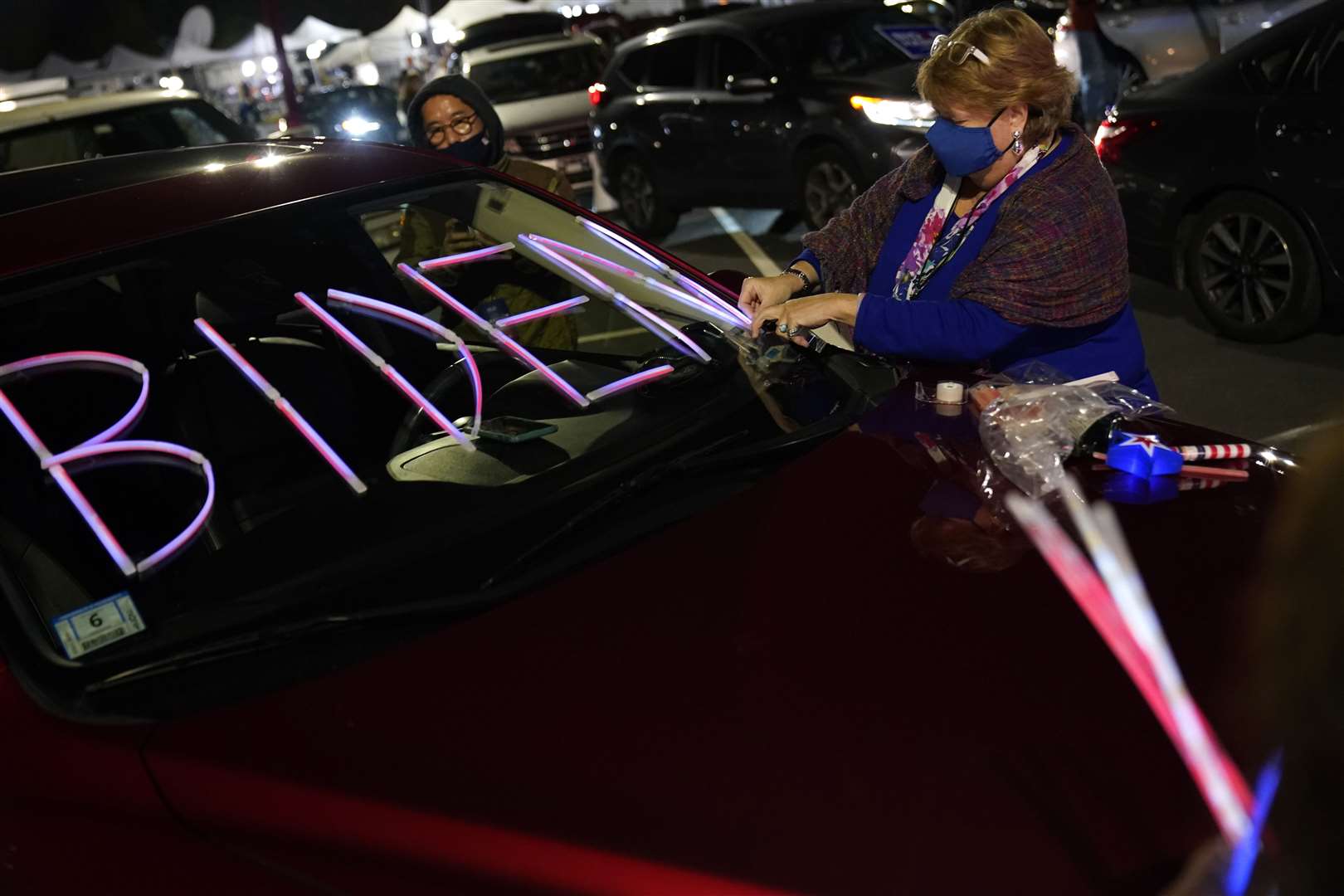 Democrat supporters decorate their vehicle as they arrive for an election night rally in Wilmington, Delaware (Andrew Harnik/AP)