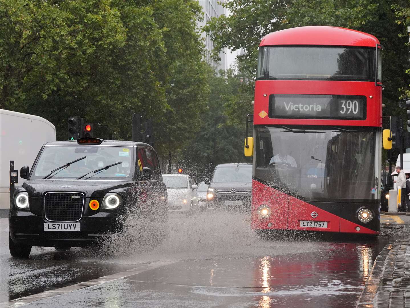 Nobody wants to be a pedestrian standing near this puddle when a bus drives through it (Jonathan Brady/PA)