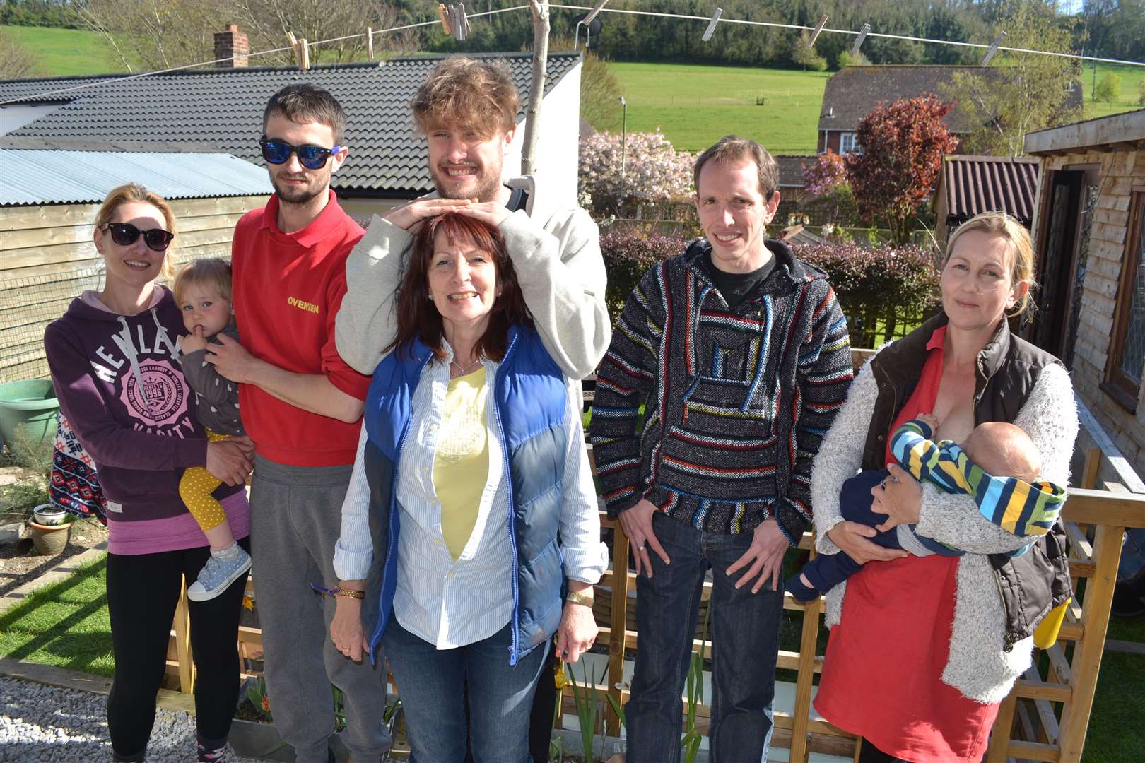 Rebecca (right) holding her baby with her mother Lyn Richards (centre) and siblings (l-r) Kate, Jacob, Jordan and Daniel