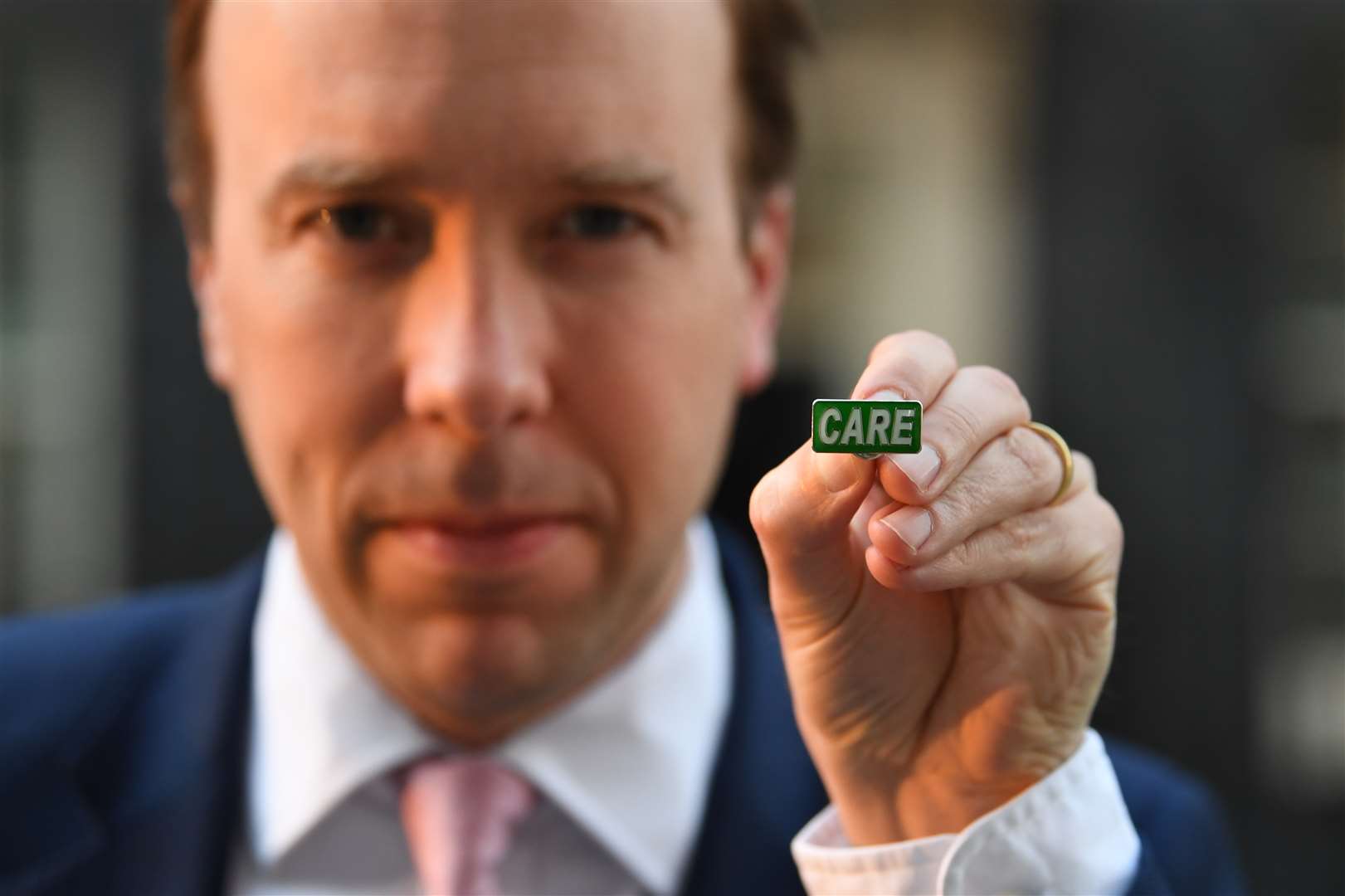Health Secretary Matt Hancock showing the new ‘Care’ badge (Stefan Rousseau/PA)