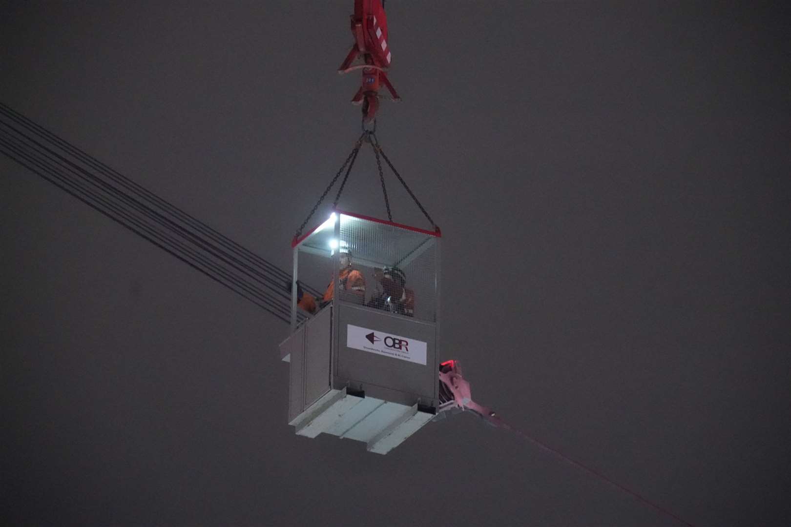 The workers used a cradle from the other crane to inspect the problem machinery (Danny Lawson/PA)