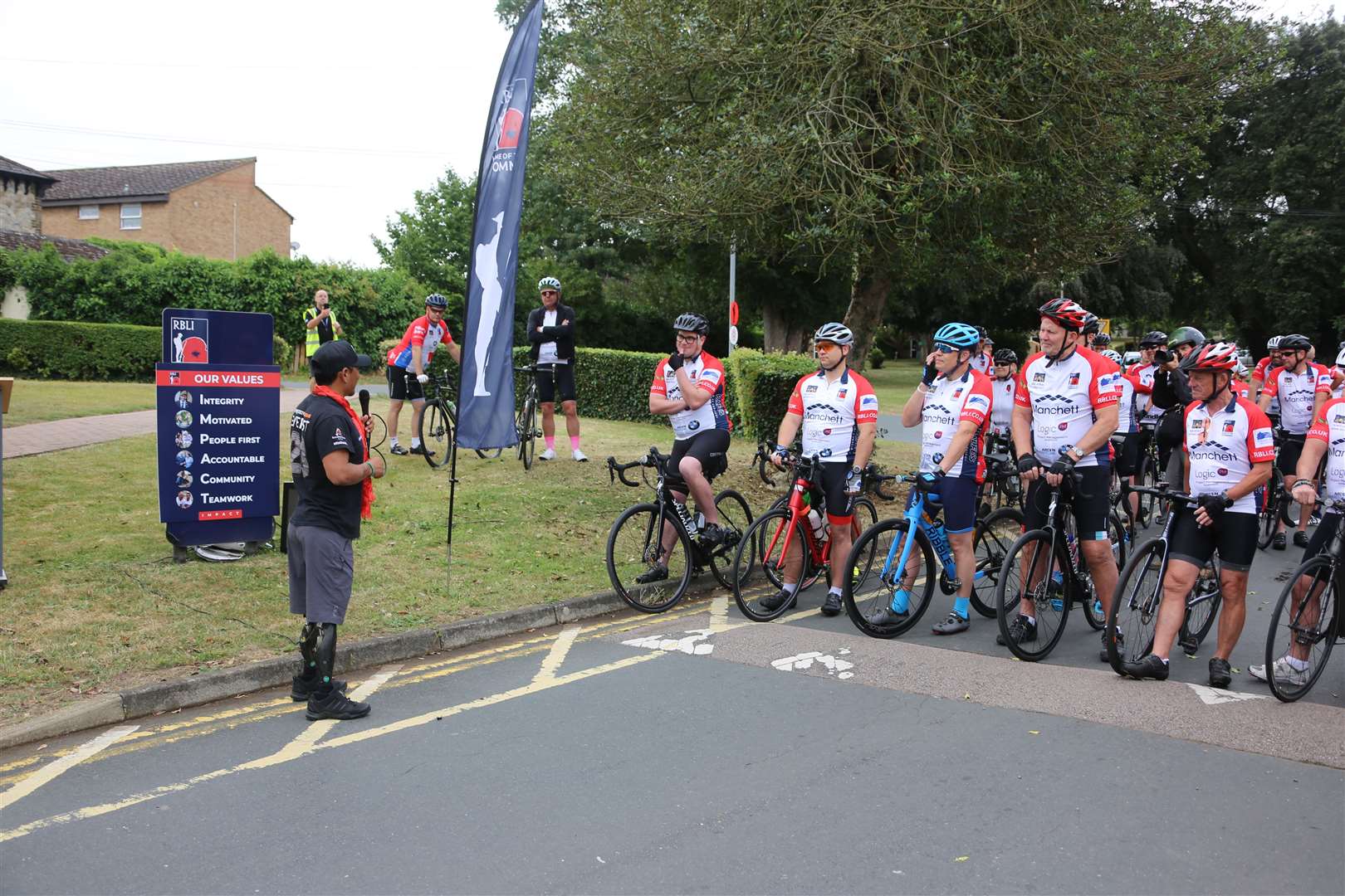 Hari Budha Magar gives encouragement to the cyclists. Photo Mike Mahoney