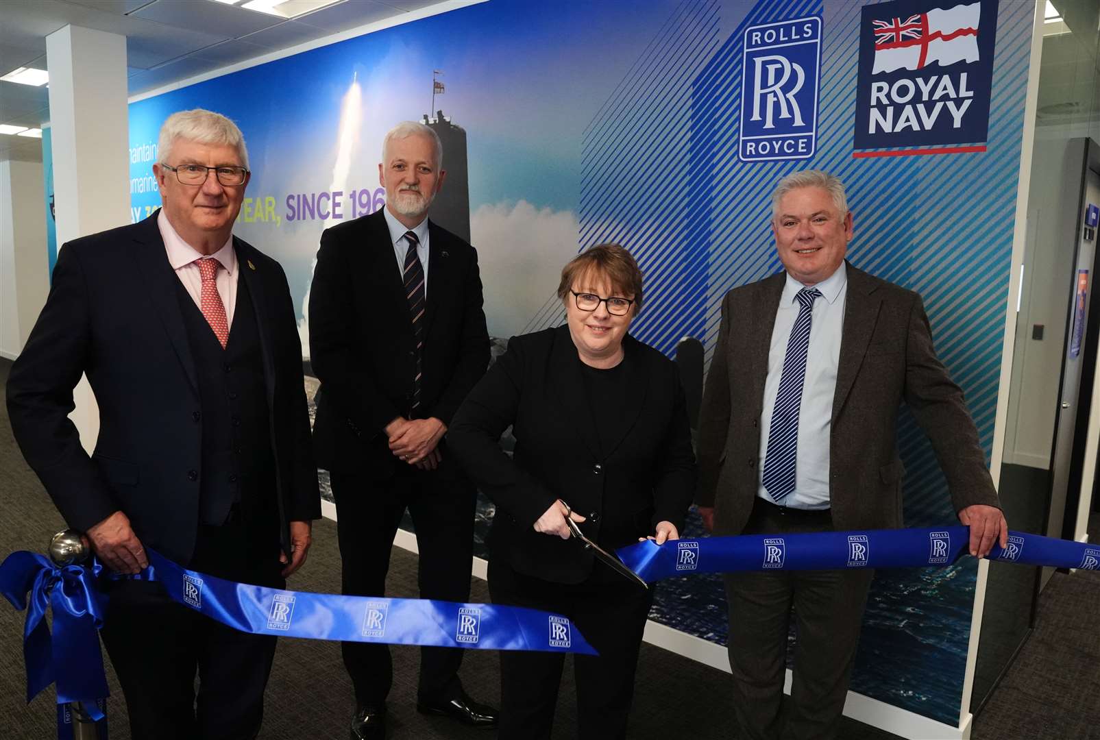 Defence minister Maria Eagle cuts a ribbon to open the office, alongside Vice-Admiral Sir Chris Gardner, far left, Commander Paul Dunn, left, and Steve Carlier of Rolls-Royce Submarines, right (Andrew Milligan/PA)