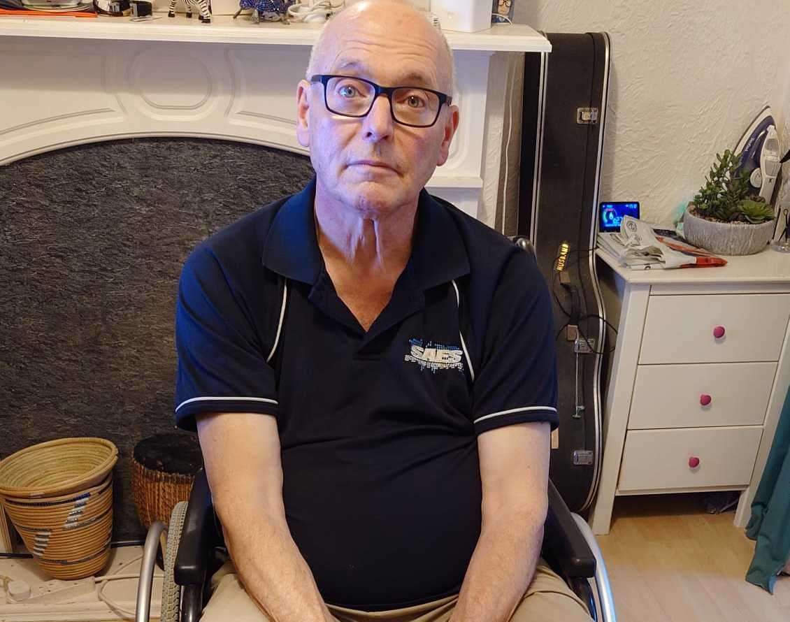 Michael Howard in a wheelchair as he waits for his appointment. Picture: Michael Howard