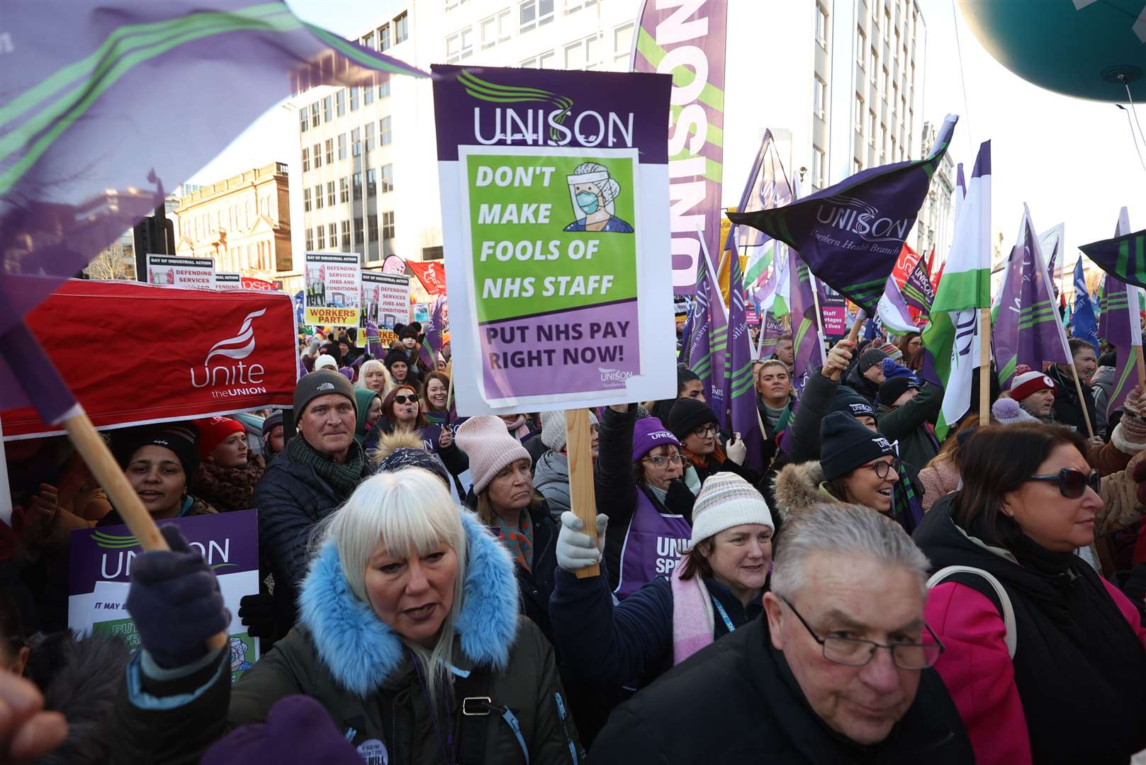 Public sector workers take part in a rally at Belfast City Hall (Liam McBurney/PA)