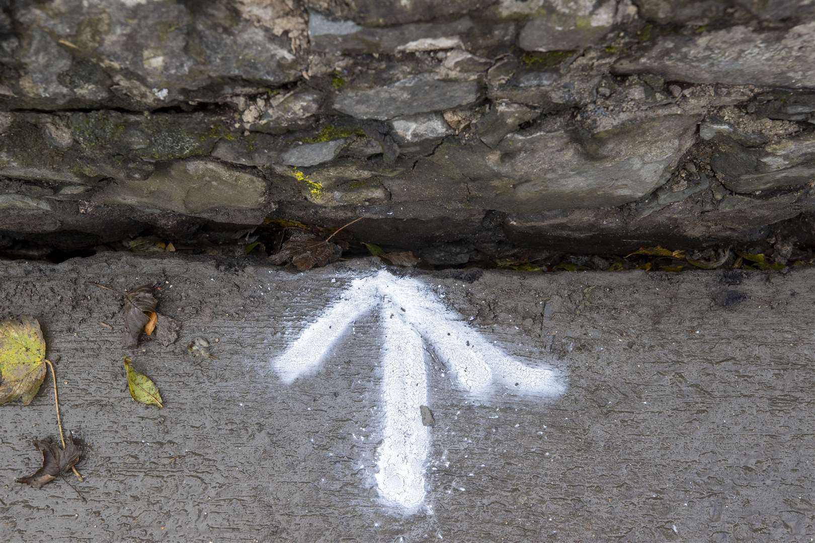 An arrow points to a spot where part of the bridge has come away from the road (PA)