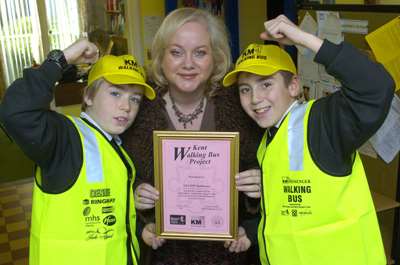 Calum and Enrico, both nine, of St Augustine's School, Tunbridge Wells present Rosie Serpis with a special thank you certificate on behalf of the Walking Bus Project, following AXA PPP healthcare's decision to sponsor the charity's road safety work.