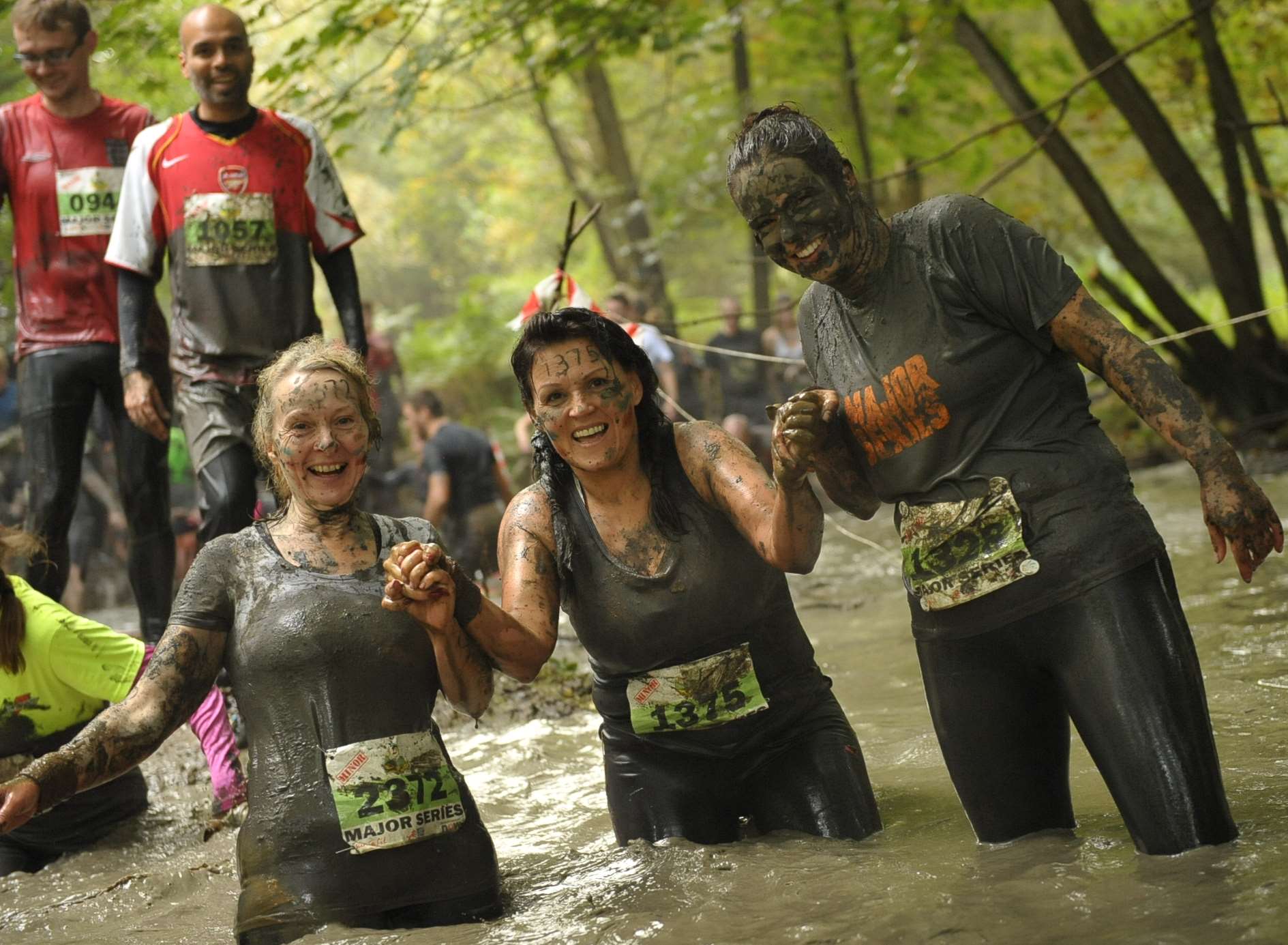 Runners taking part in the muddy obstacle course