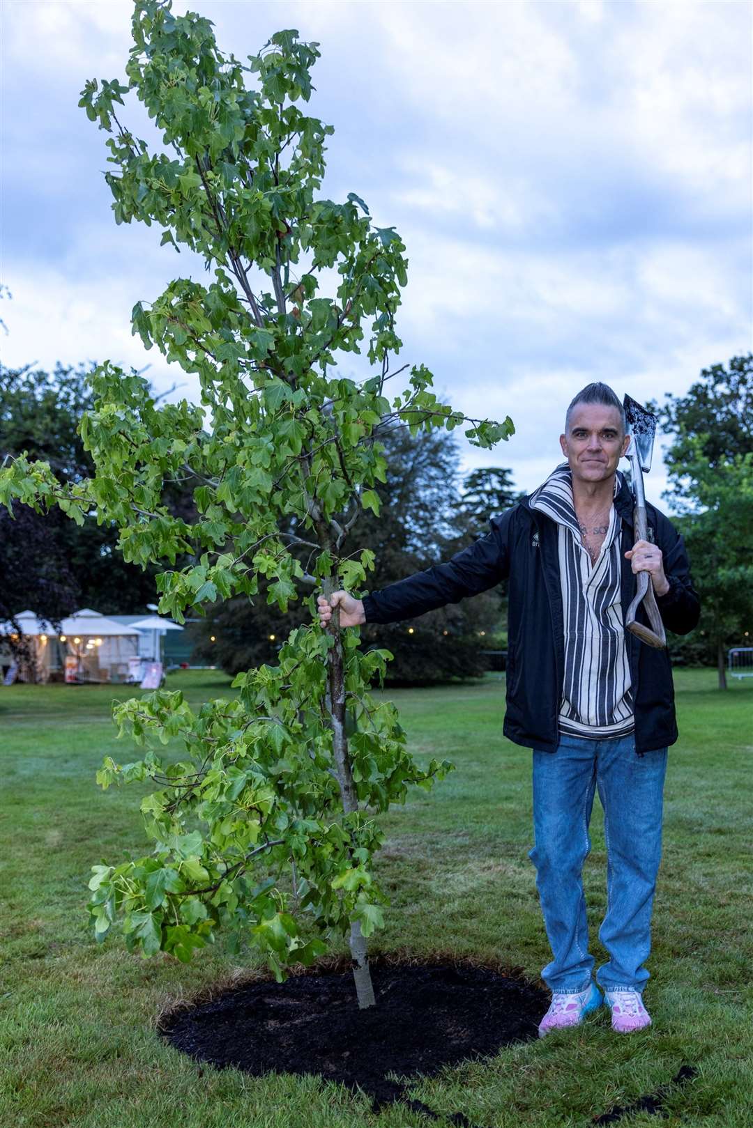 Robbie Williams plants a tree on the Sandringham Estate in Norfolk (Rupert Frere/Heritage Live)