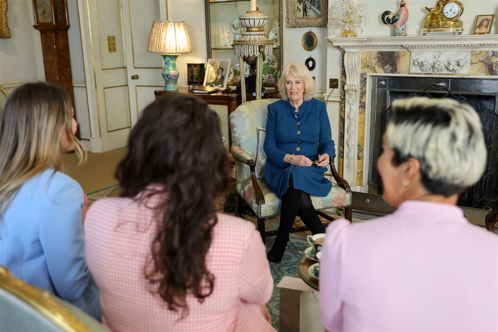 Camilla, hosts (L-R) Charlotte Irving, Abby Johnston and Kat Cordiner at Clarence House. Chris Jackson/PA