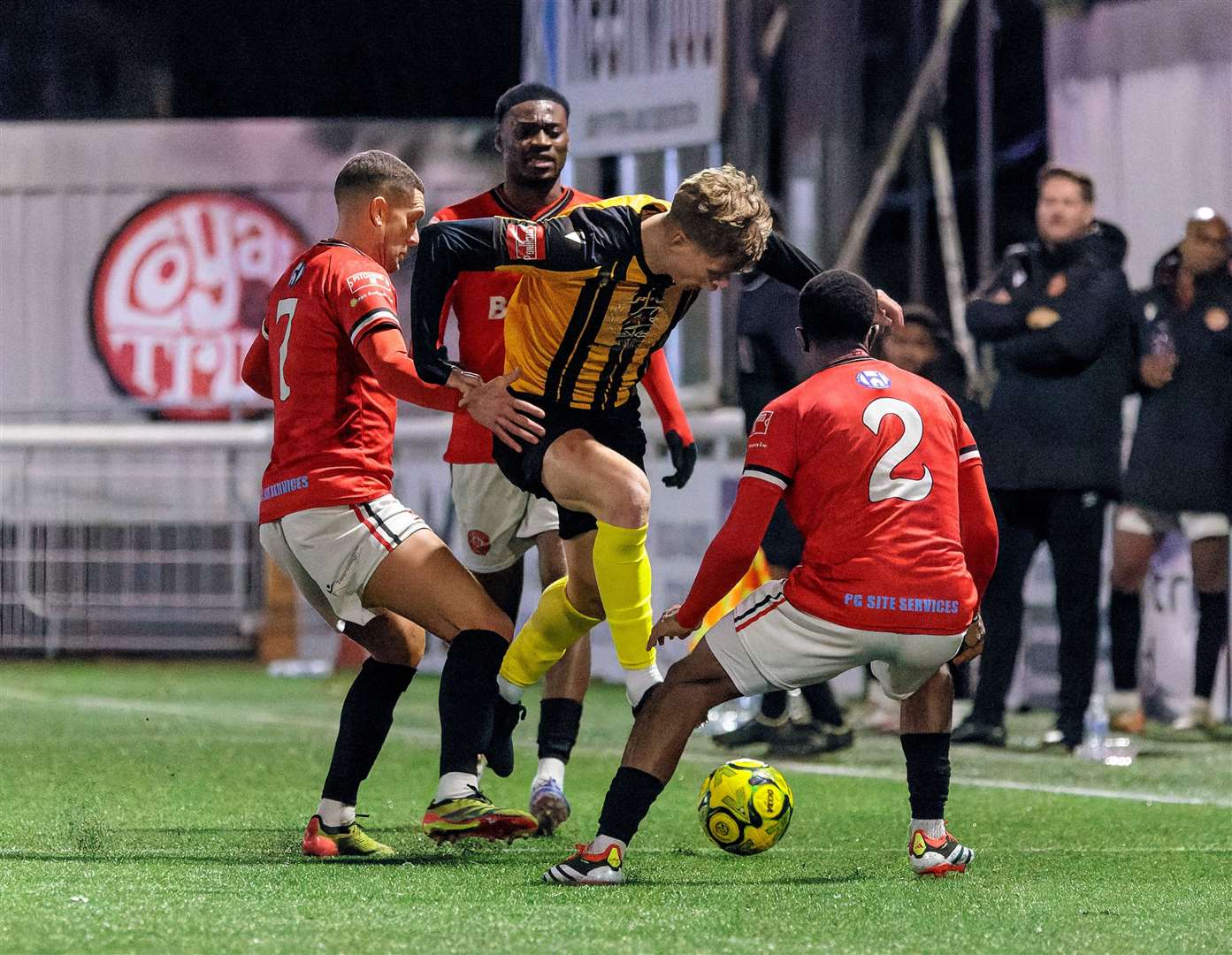 Chatham get three men round Folkestone substitute Sam Smith. Picture: Helen Cooper