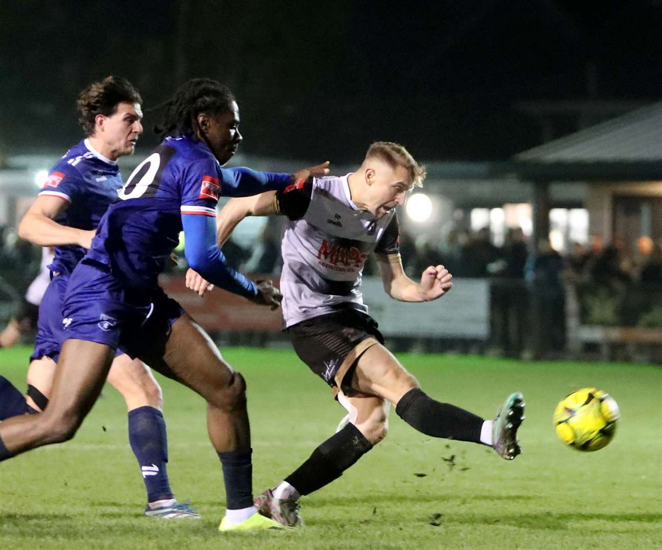 Tom Chapman fires wide for Deal under pressure from two Margate players in the Hoops’ 1-0 home Isthmian South East loss last Tuesday. Picture: Paul Willmott