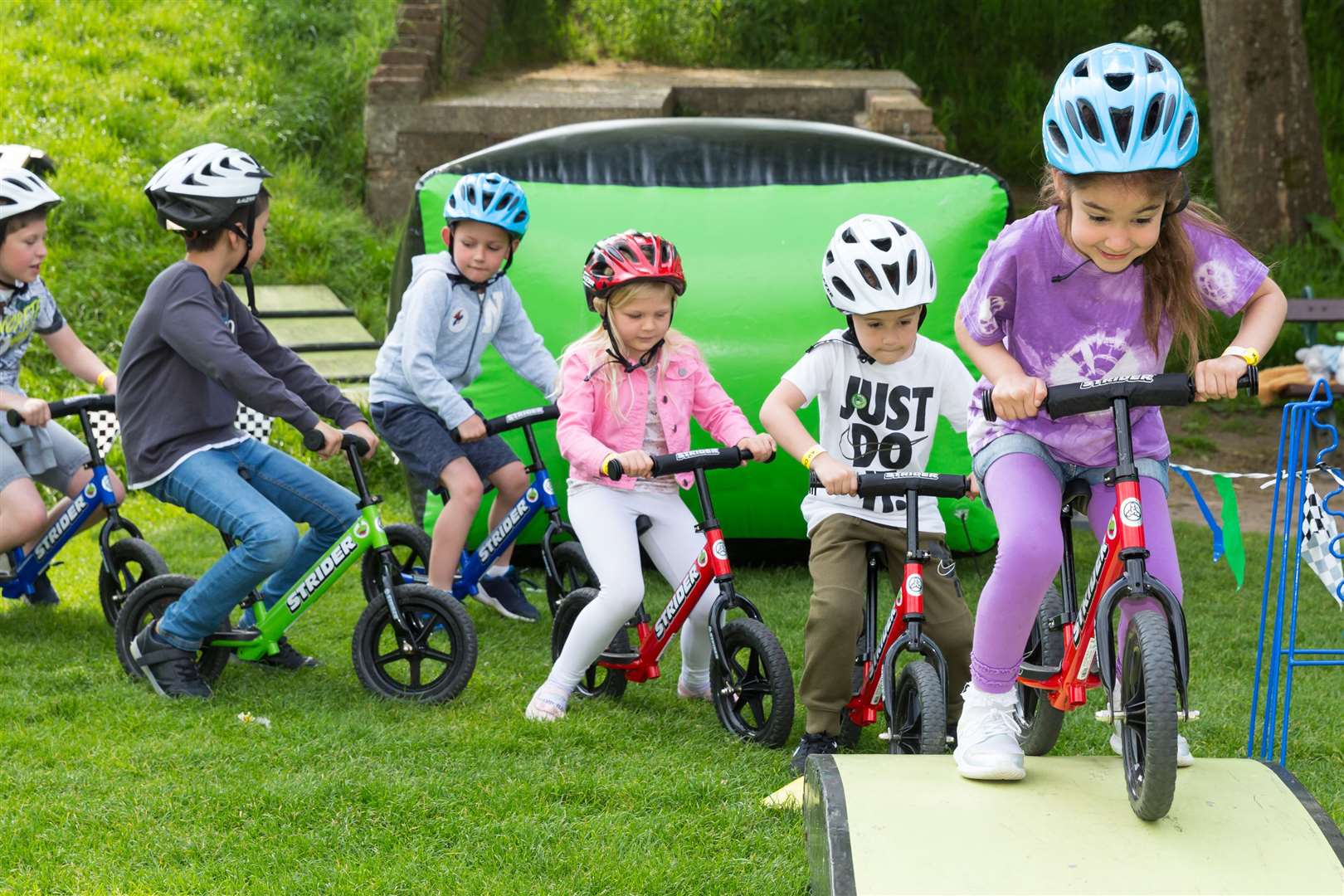 Misa, aged five, from Palace Wood Primary School in Maidstone leads the charge on the balance bikes adventure course at Buster's Big Bash held at Dane John Gardens, Canterbury.