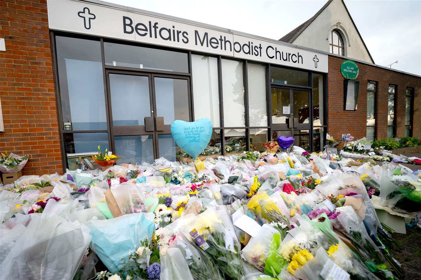 Flowers and tributes at the scene near Belfairs Methodist Church in Leigh-on-Sea, Essex, where Conservative MP Sir David Amess died in October 2021 (Aaron Chown/PA)