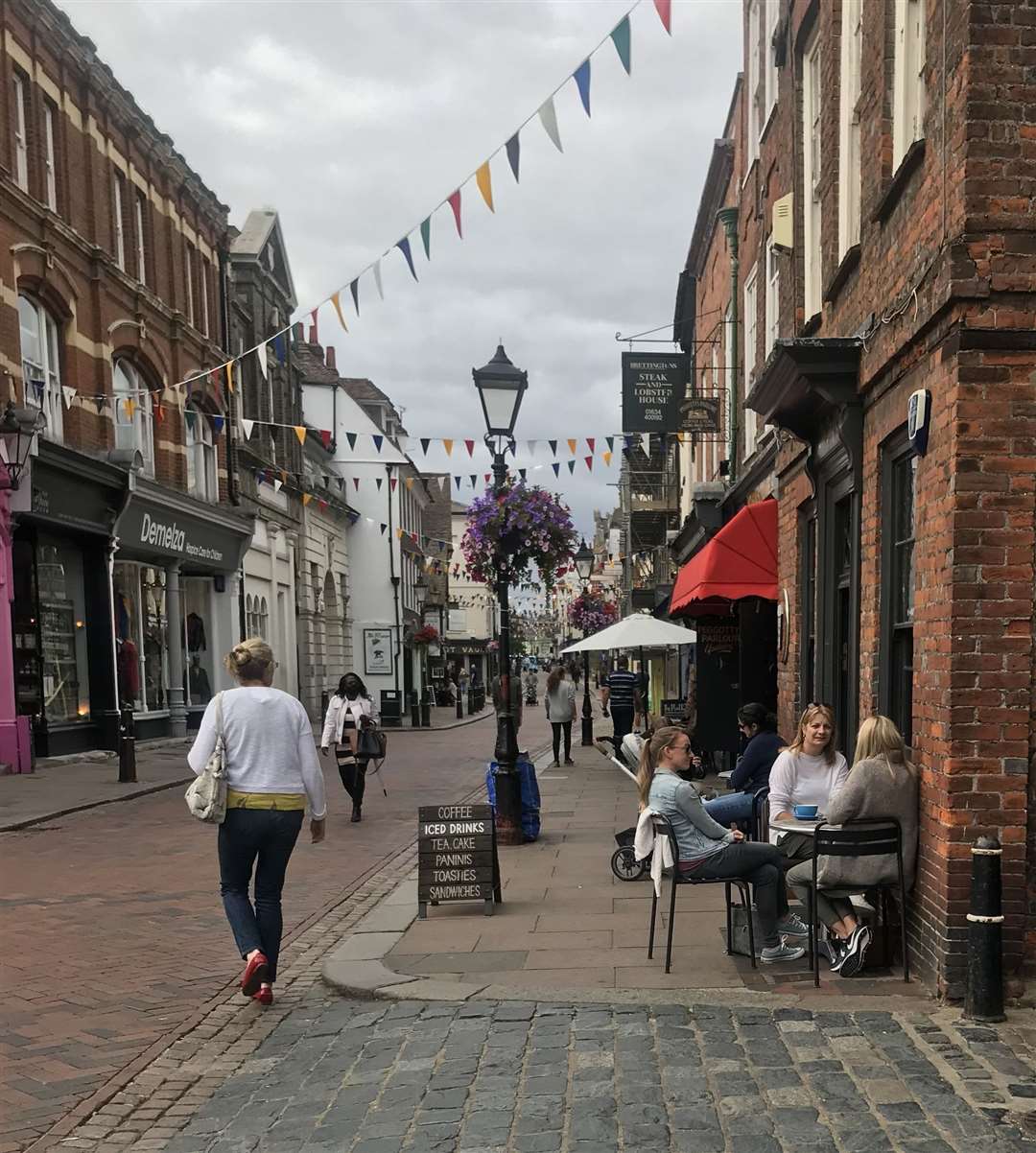 People enjoying al-fresco cuppas in the high street