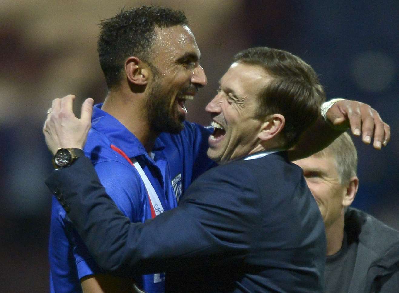 Leon Legge celebrates at the final whistle with manager Justin Edinburgh after the draw at Preston