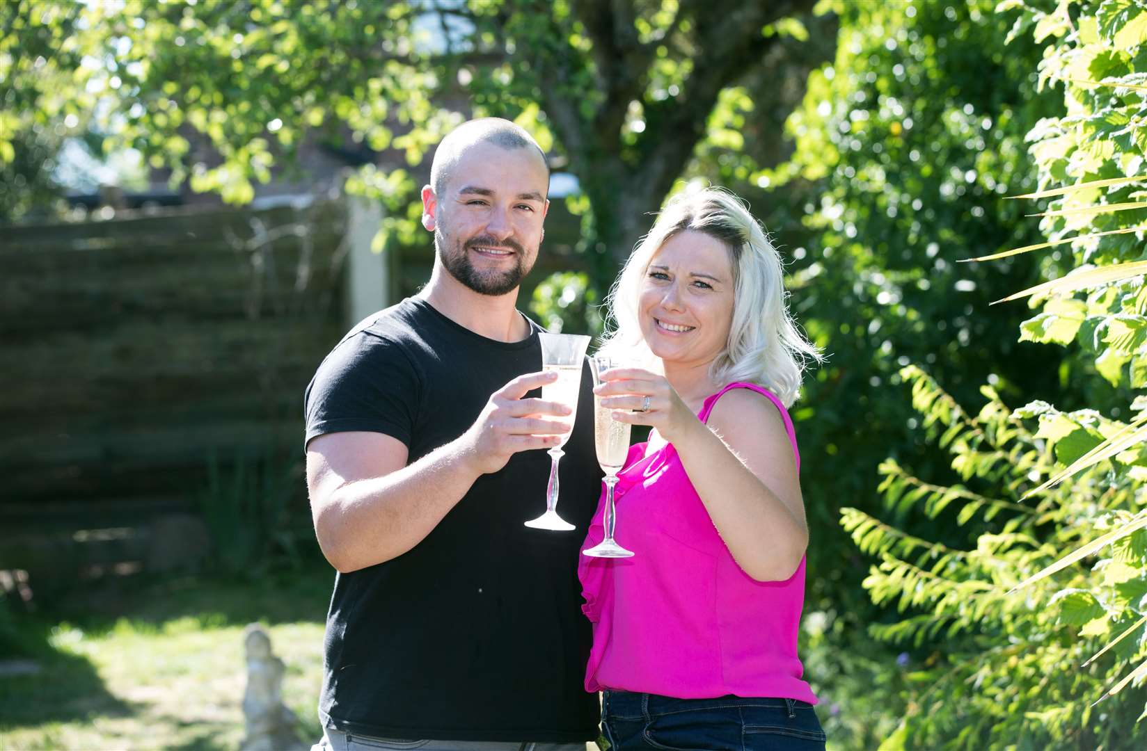 Rich Pearson, 30, and wife Kim, 33, celebrate winning £10,000 per month for a year in the Set For Life draw (National Lottery/ PA)