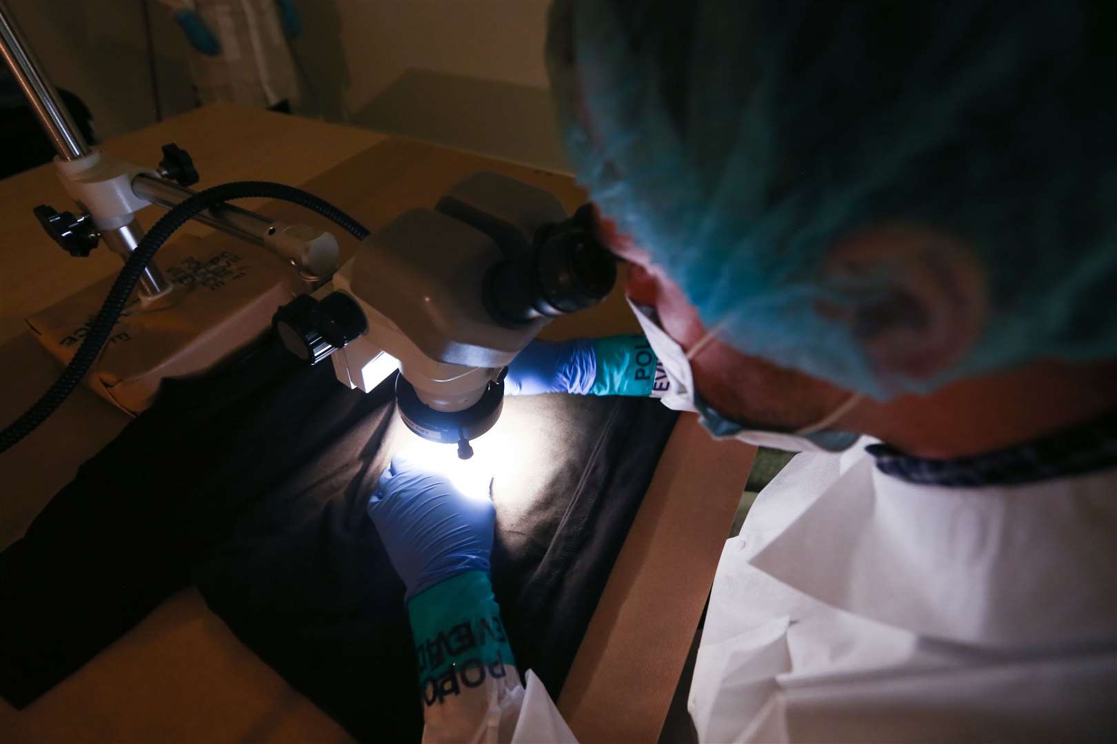 Forensic examiners show the traditional method of detecting blood (James Manning/PA)