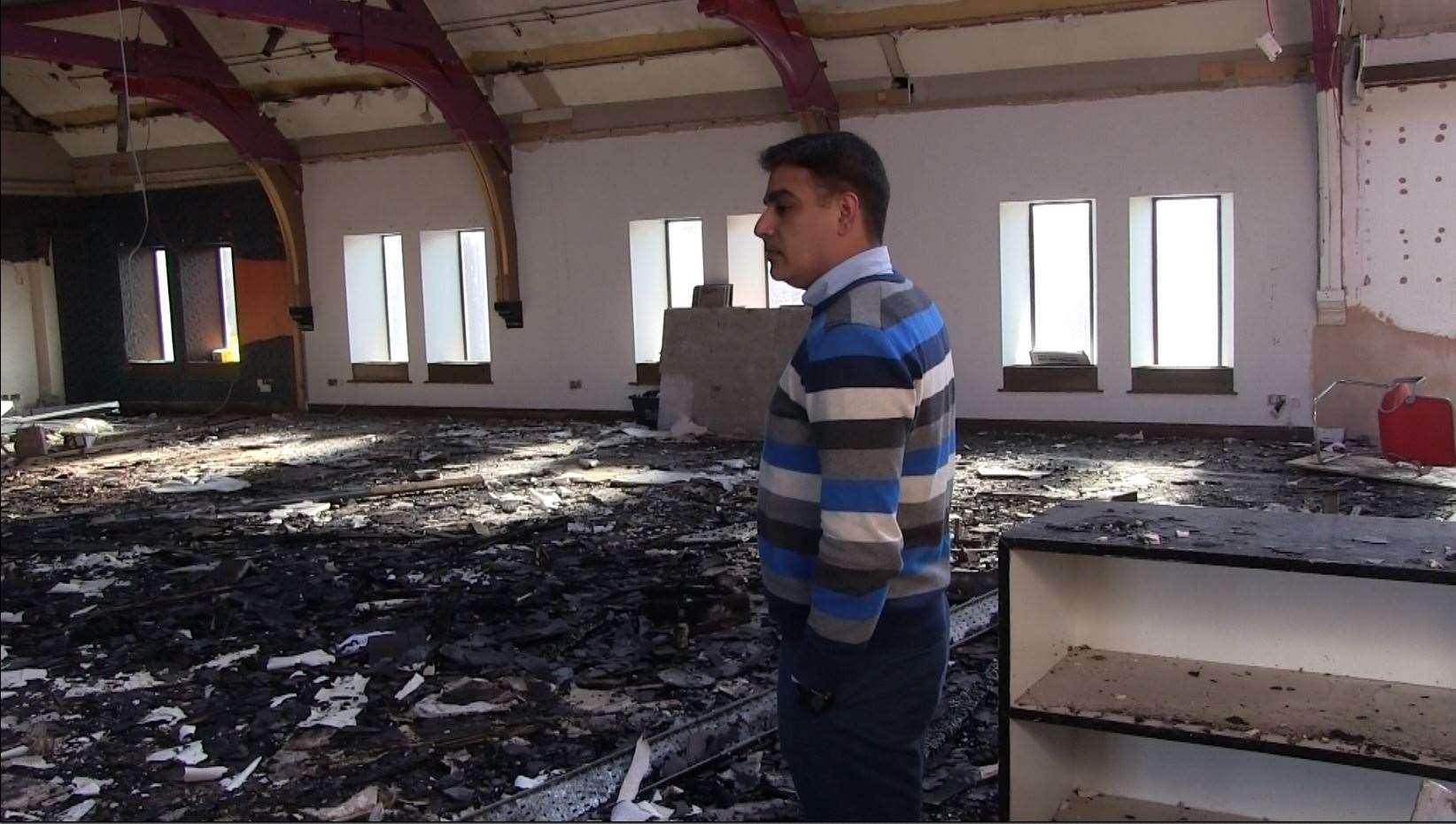 Association trustee Muhammad Atif surveys the damage inside the building (David Young/PA)