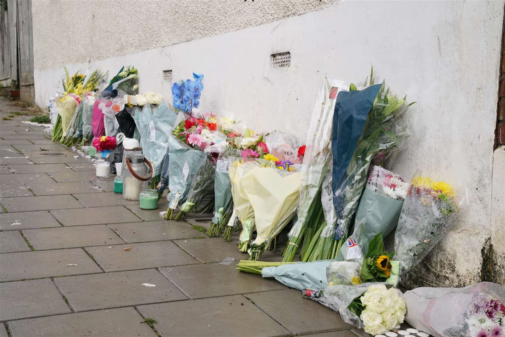 Flowers were left at the scene in Kirkstall Gardens (Jonathan Brady/PA)