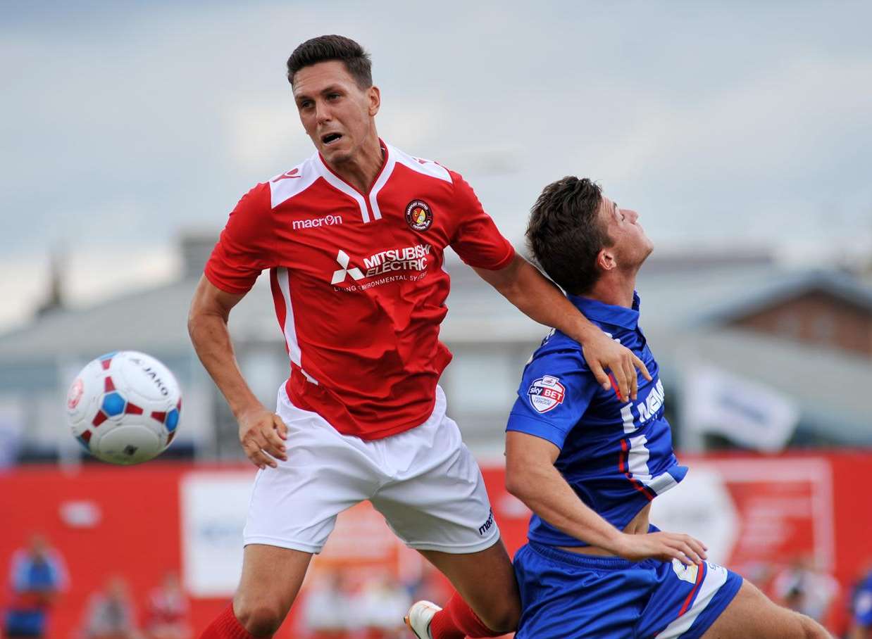 Joe Howe challenges Gillingham's Brennan Dickenson Picture: Richard Eaton