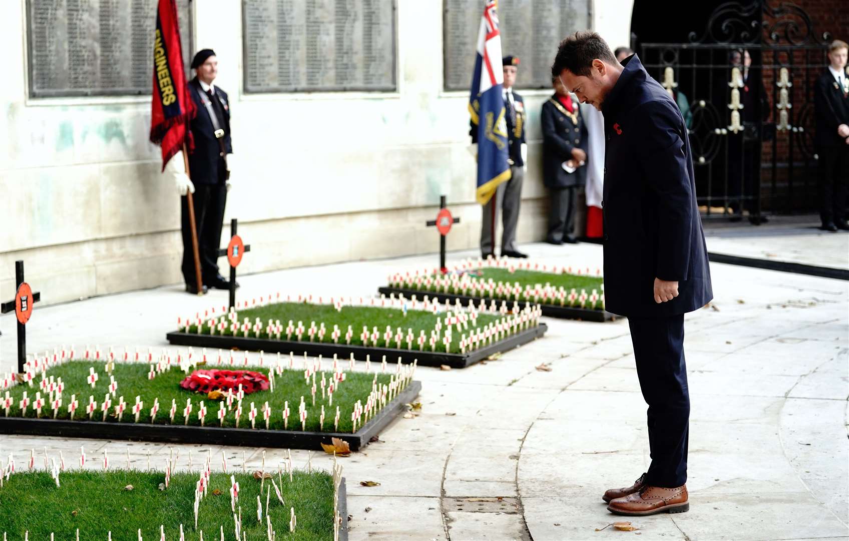 Stephen Morgan, Labour MP for Portsmouth South, bows his head after planting a cross of remembrance during an Armistice Day service in Guildhall Square, Portsmouth (Andrew Matthews/PA)