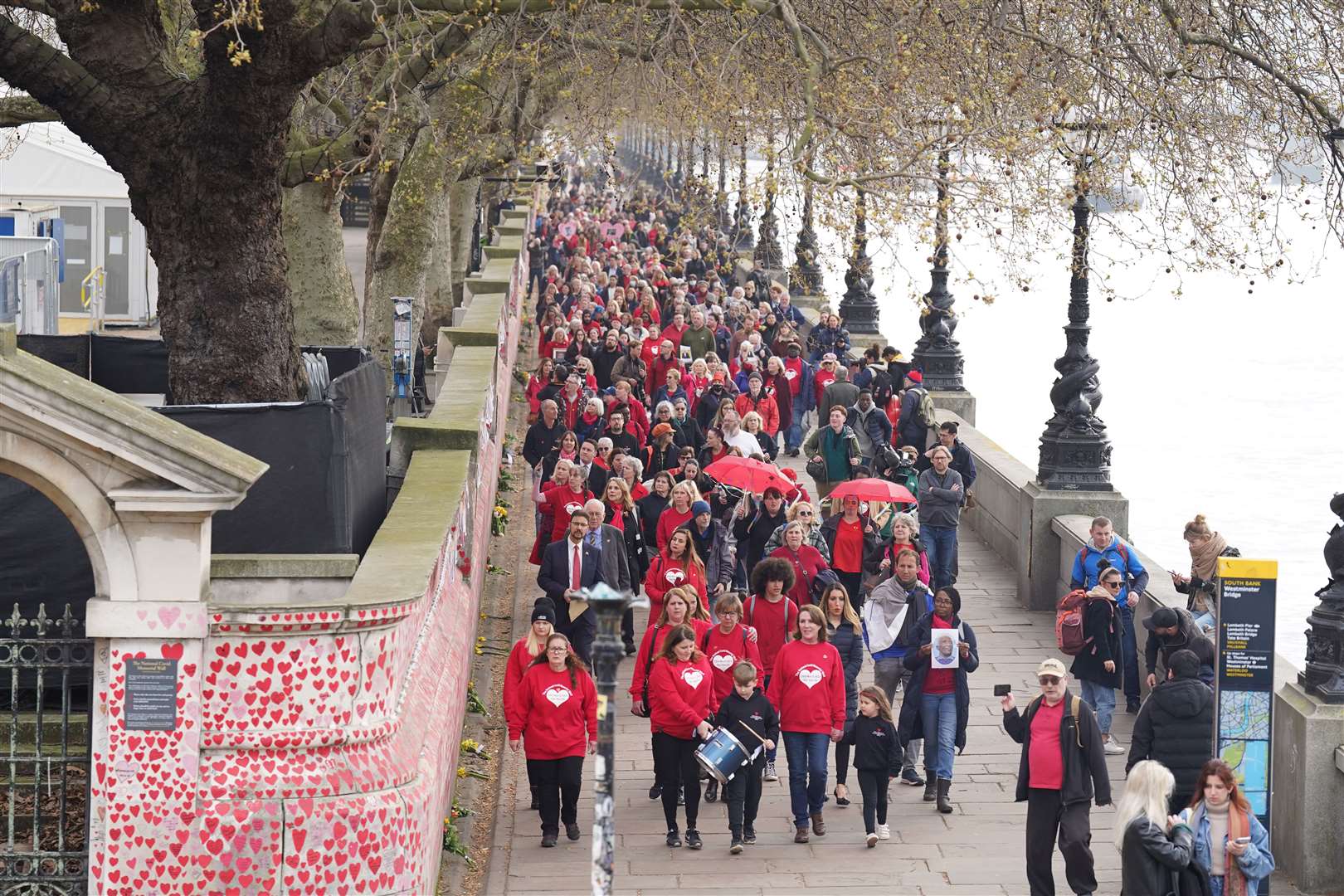 Bereaved families gather to mark the one-year anniversary of the National Covid Memorial Wall, London (Stefan Rousseau/PA)