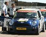 TRAGEDY: Father James Needham, leaning against the car, and his son Darren, inside the Mini, before the accident