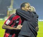 A hug from the chariman, Paul Scally, for Gills player Tony Sinclair