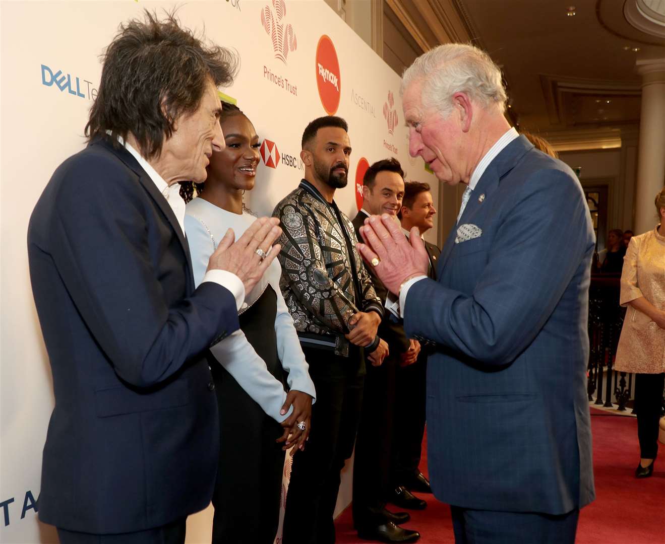 The Prince of Wales uses a namaste gesture to greet Rolling Stone Ronnie Wood as he arrives at the annual Prince’s Trust Awards 2020 held at the London Palladium in March (Yui Mok/PA)