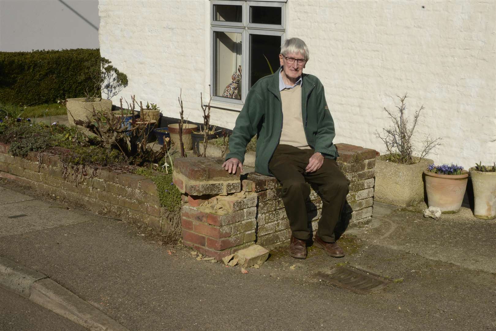 Neil Campbell by his wall that was knocked down by a Tesco Van. Picture: Paul Amos