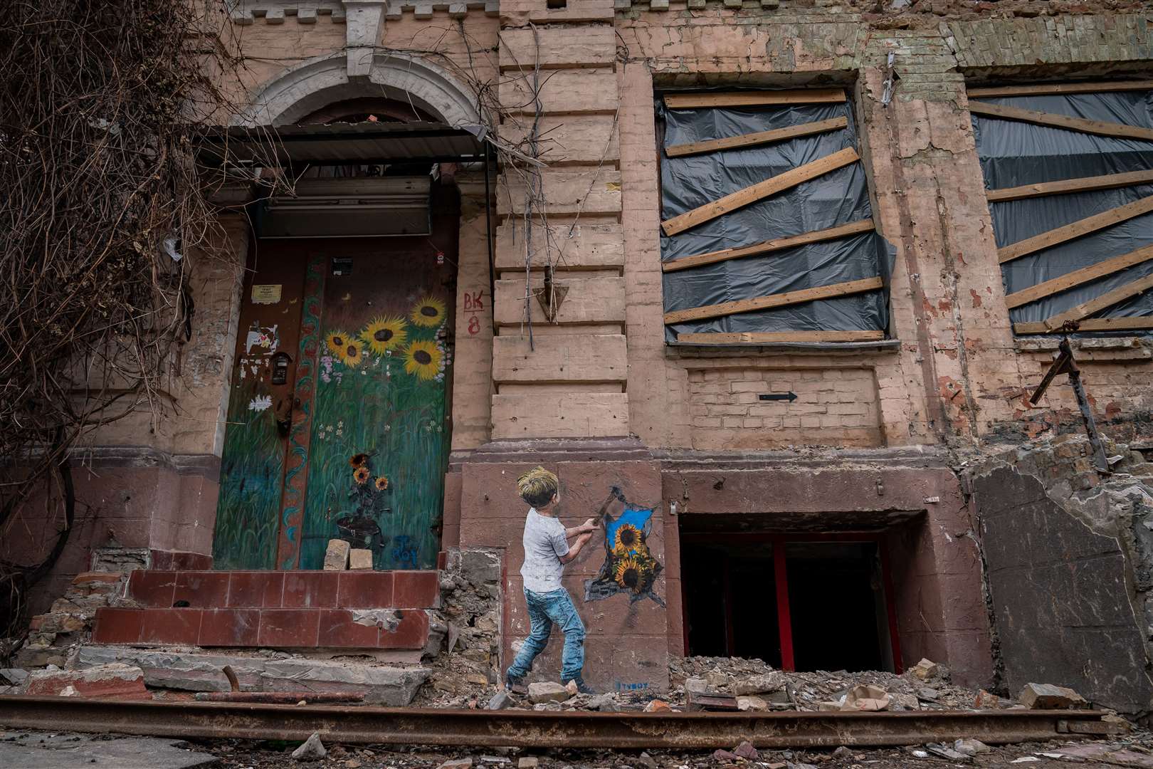 Artwork painted on a damaged apartment block in the Kyiv ahead of the first anniversary of the Russian invasion of Ukraine (Aaron Chown/PA)