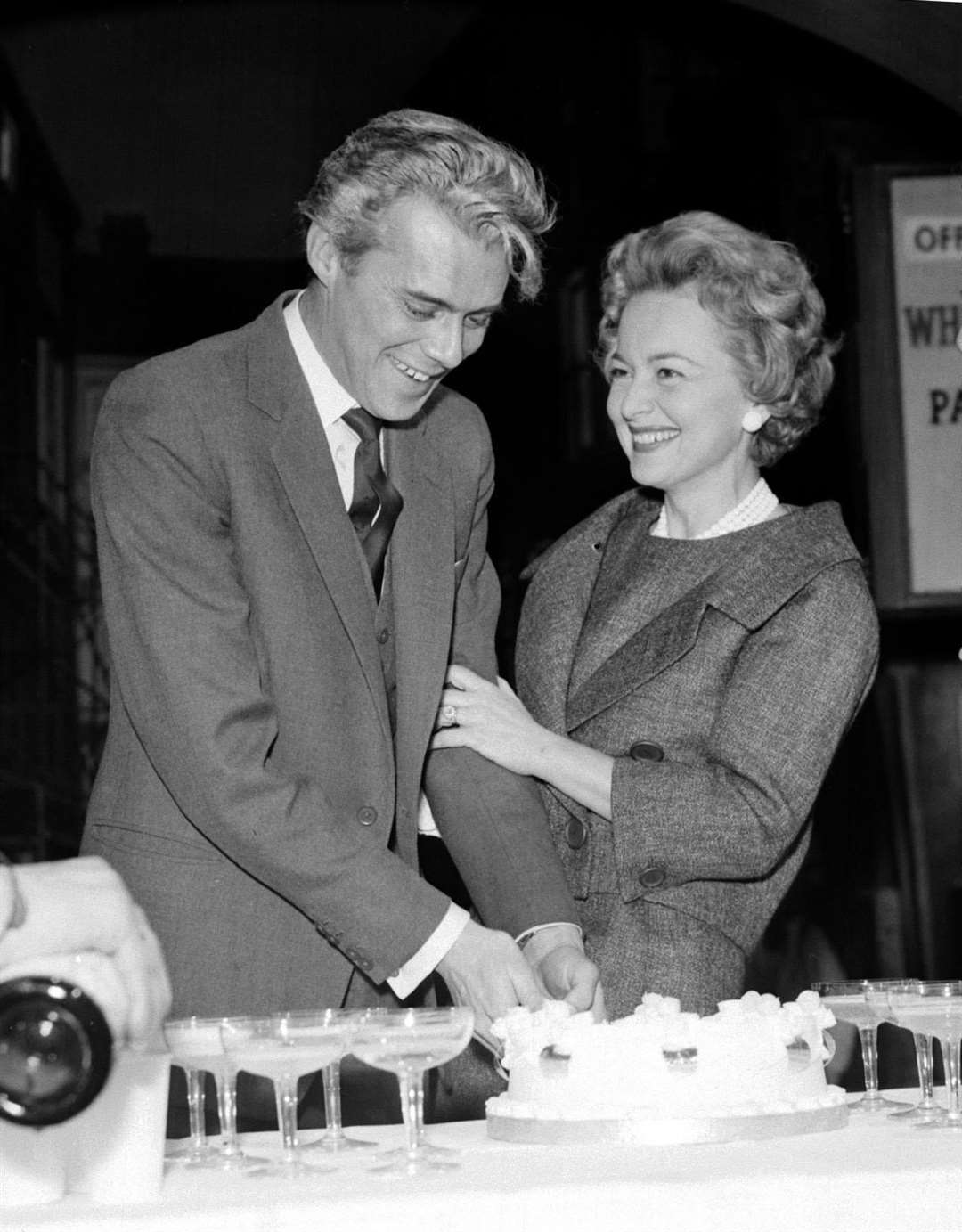 Sir Dirk Bogarde cuts his birthday cake with Dame Olivia de Havilland (PA)