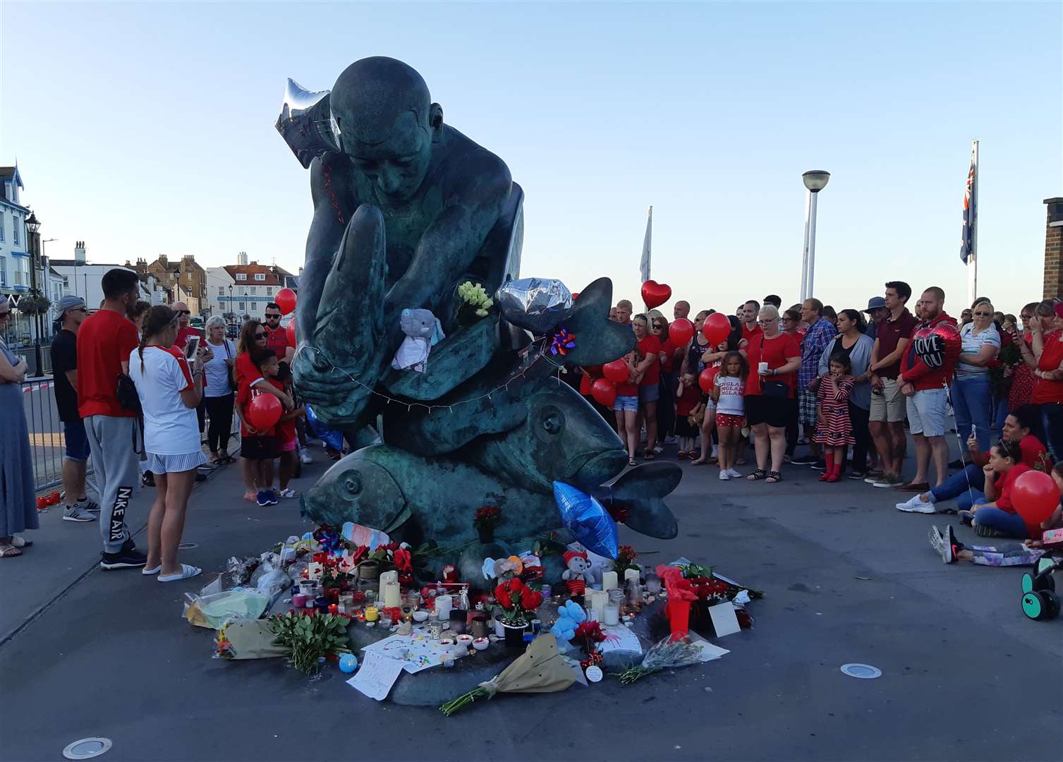 The mass of tributes around the Deal Pier statue last night