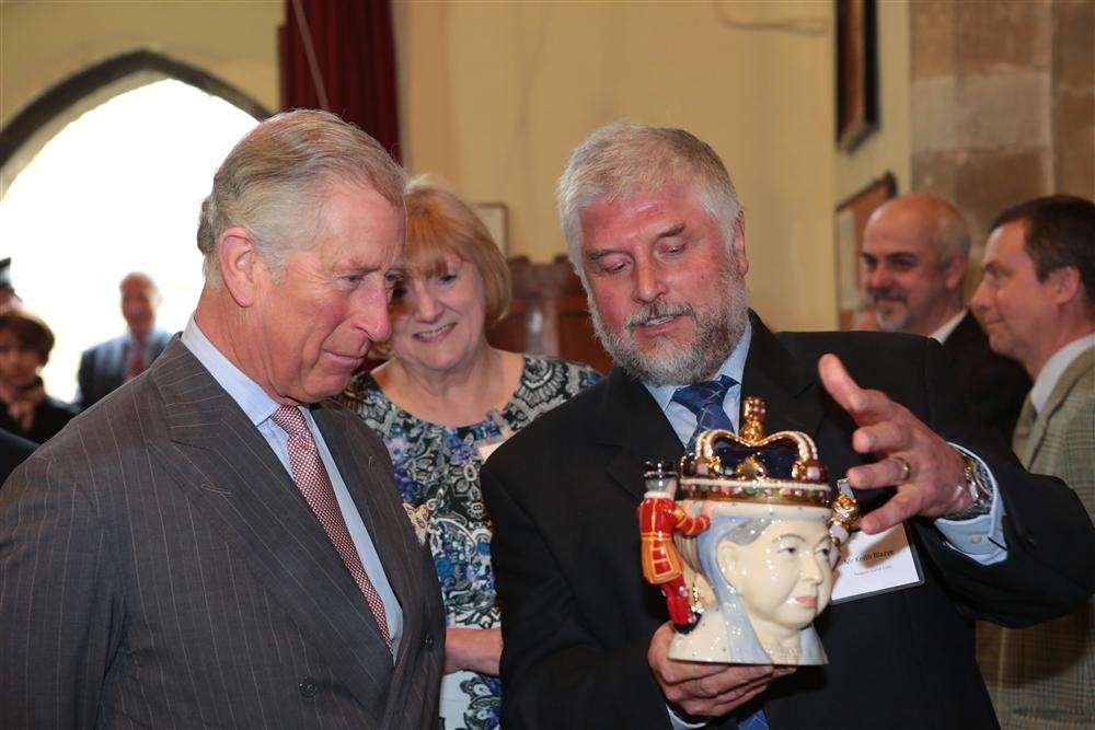 The Prince of Wales is presented with a teapot depicting the Queen on one side and Queen Victoria on the other. Picture: Martin Apps