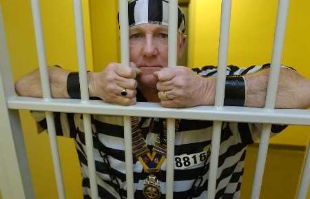 CHARITY STINT: David Hatcher, president of Medway Rotary Club, behind bars at Medway Police Station. Picture: GRANT FALVEY