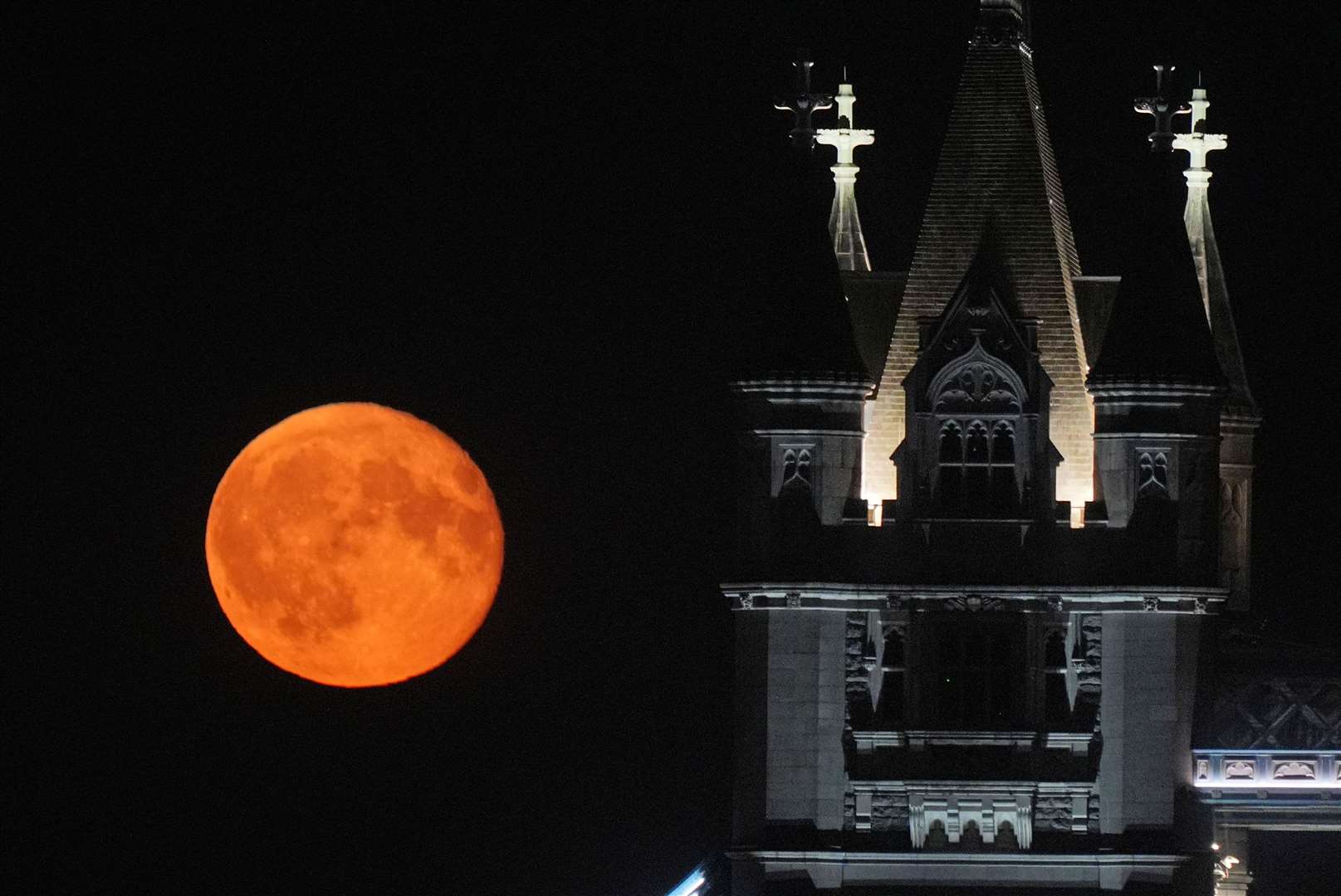 A waning gibbous moon rises over Tower Bridge in London on August 20 (Yui Mok/PA)