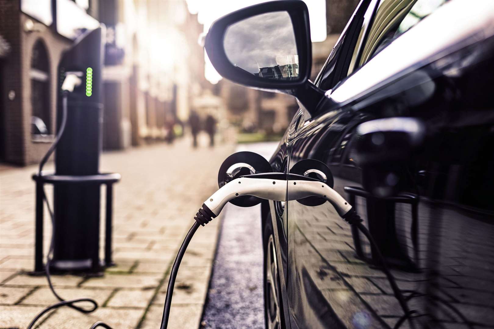 An electric vehicle charging in a UK street