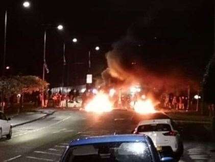 A barricade burns in the middle of North Road in Carrickfergus during another night of loyalist disorder (PA)