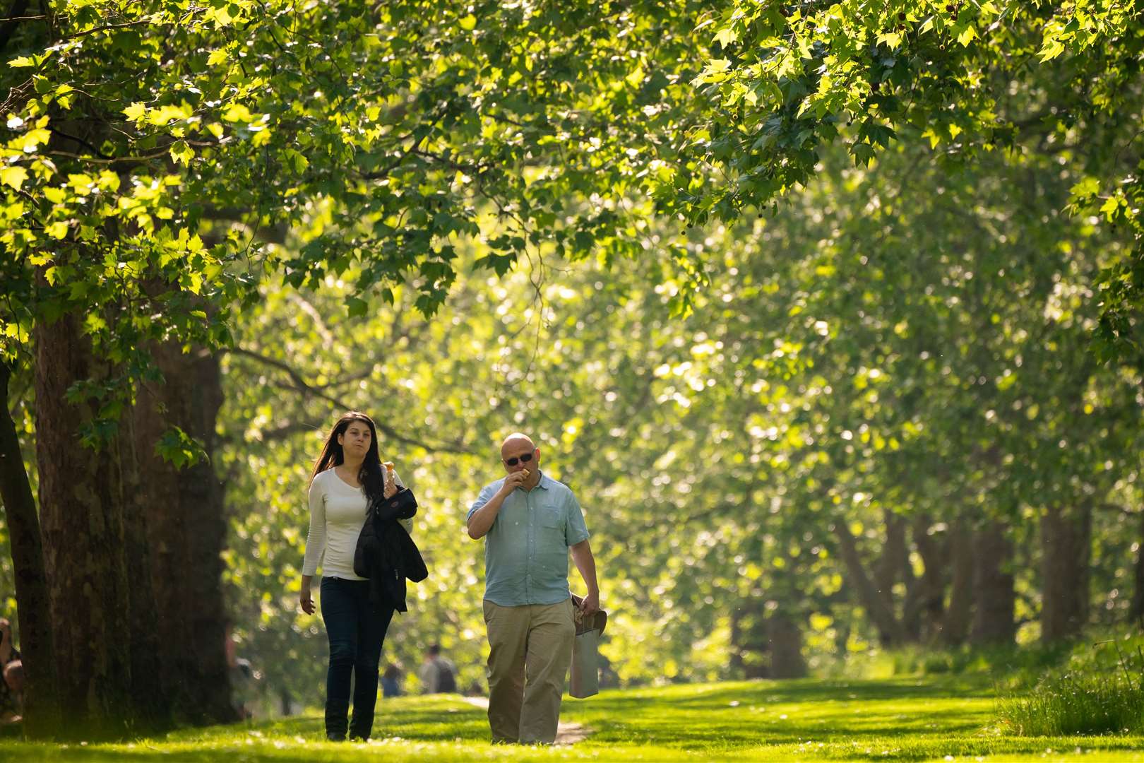 The sun shone on those enjoying a stroll in the park (Aaron Chown/PA)