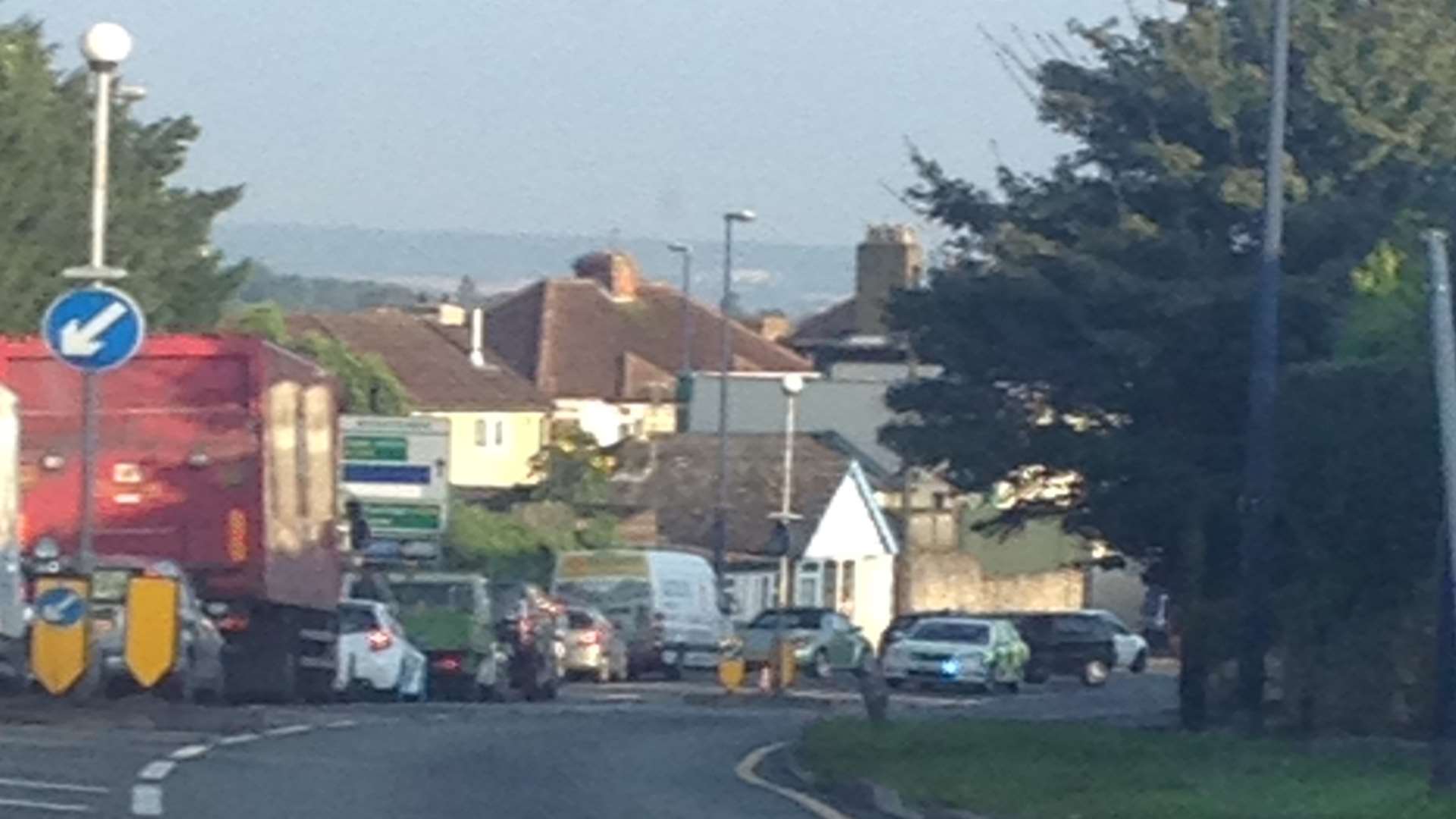 A police car is stationed in front of a damaged vehicle on Sutton Road, Maidstone.