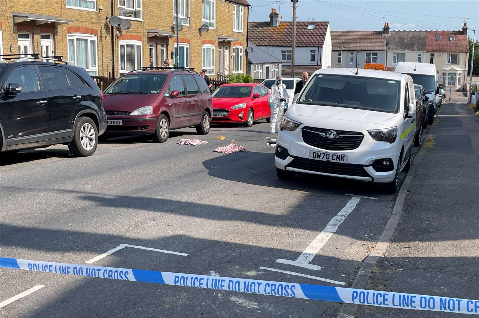 Officers have been searching in bins and photographing items in the road