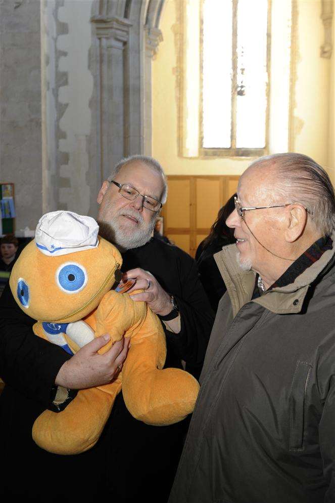 Father John Rosenthal tries to tempt Denys Le Fevre into buying a cuddly toy at the Trash and Treasure sale at St Nicholas At Wade Church.