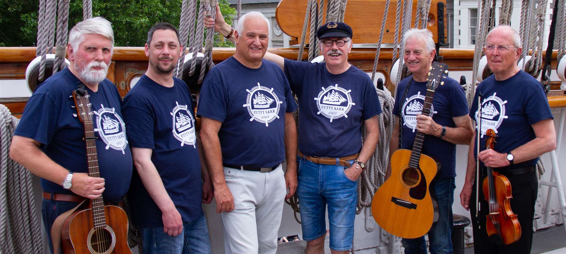 Joe, Andy, Pete, Colin, Dave and David performing on board the Cutty Sark